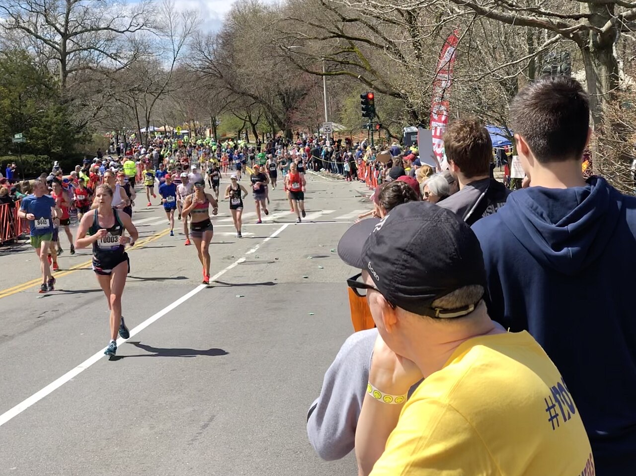 Runners crossing Walnut Street in Newton during the 2019 Boston Marathon