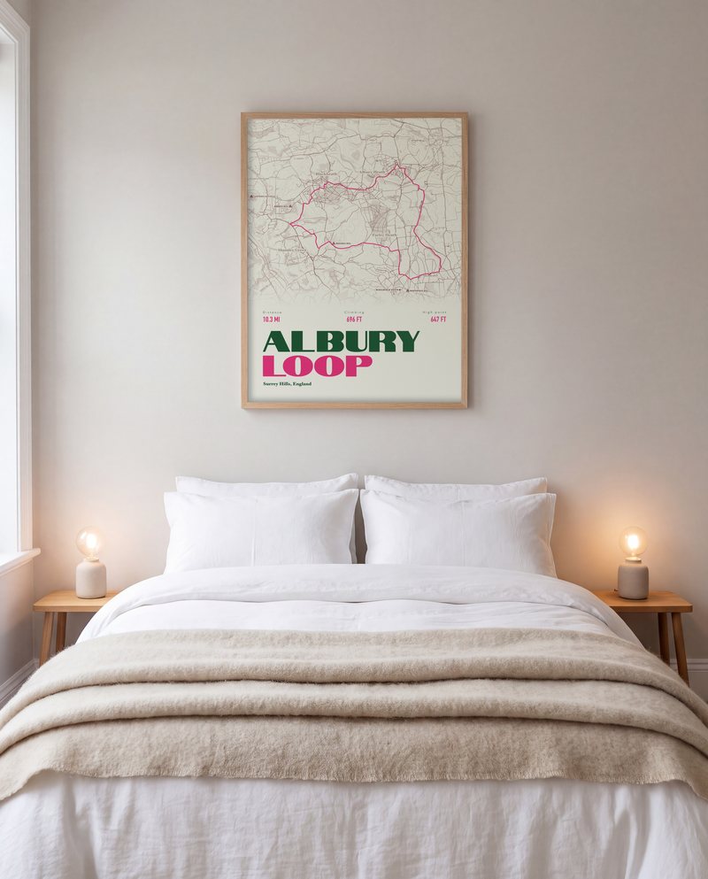 A Albury Loop walking print in Cream, in a natural wood frame, above a bed