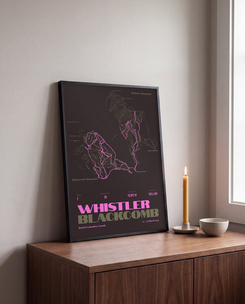 A Whistler Blackcomb ski print in Black Bean, in a black frame, leaning on a sideboard
