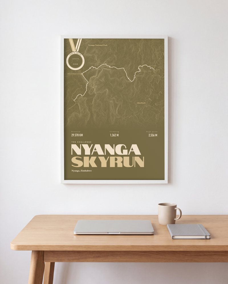 A Nyanga Skyrun running print in Olive, in a white frame, above a desk
